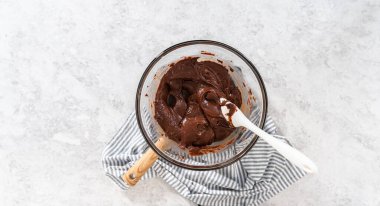 Düz yatıyordu. Çikolata parçacıkları ve diğer malzemeleri kaynayan suyun üzerinde karıştırarak fındıklı çikolatalı şekerleme hazırlıyorum..