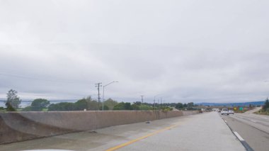 Kederli, bulutlu bir kış gününde, California, Rincon Sahili yakınlarında 101. Otoyol 'da araba sürüyorum..