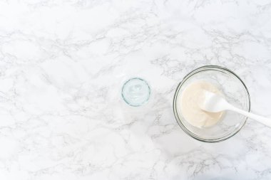 Düz yatıyordu. Şekerli kurabiyeleri süslemek için boru torbalarına ev yapımı kraliyet kreması aktarılıyor..