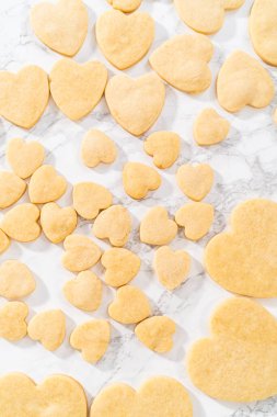 Sevgililer Günü için pembe ve beyaz kraliyet kremalı kalp şeklinde kurabiyeler..