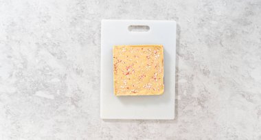 Flat lay. Scoring candy cane fudge into the reusable plastic bag.