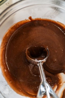 Cupcake folyoları titizlikle hem çikolata hem de vanilya hamuruyla dolduruluyor. Lezzetli çeşitlilikte doğum günü kekleri pişirmek için zemin hazırlıyorlar..