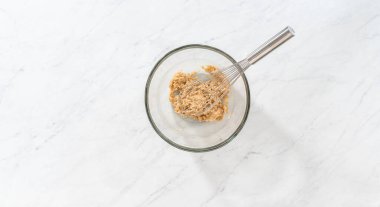 Flat lay. Mixing wet ingredients in a small glass mixing bowl to bake gingerbread bundt cake with caramel filling.