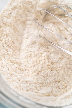 Kuru malzemeyi büyük bir bardakta çırpma kabıyla karıştırıp krem peynirli havuçlu kek pişirmek..