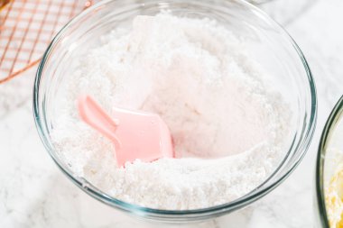 Zengin, pürüzsüz bir krem peynirli krema hazırlamak için el çırpma makinesi kullanarak malzemeleri ustalıkla birleştirirsin ki bu da kekin süslemesi için mükemmeldir..