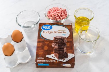 Denver, Colorado, USA-December 31, 2022-Measured ingredients in glass mixing bowls to prepare peppermint brownies.