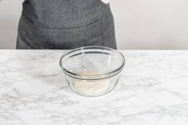 Ev yapımı kraliyet kreması yapmak için büyük bir cam karıştırma kabında malzemeleri karıştırıyorum..