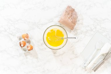 Düz yatıyordu. El çırpma makinesiyle, malzemeler cam karıştırma kabında ustalıkla karıştırılarak nefis bir çikolatalı kek elde ediliyor..