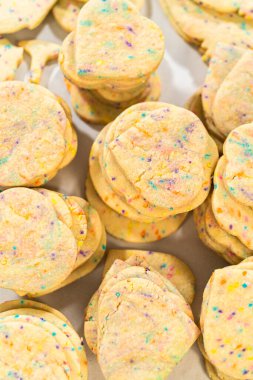 Büyük miktarda şekerli kurabiye düzgünce pişirme tepsisine istiflenmiş, paketlerinin kırsal kahverengi karton kutulara konmasını bekliyor..