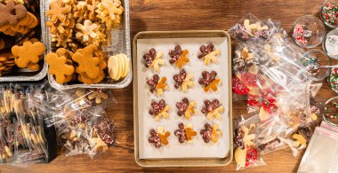 Dikkatlice paketlenmiş Noel kurabiyeleri, çikolataya batırılmış ve şeffaf selofan ambalajla sunulmuş, bayram hediyesi olarak mükemmel..