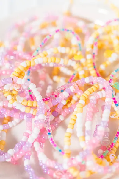 Little girls charming bracelets adorned with clay and sea beads.