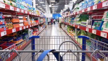 Castle Rock, Colorado, USA-March 21, 2024-The view from a shopping cart unveils expansive aisles and bulk products at Sams Club, a shopping sanctuary offering variety and value. clipart