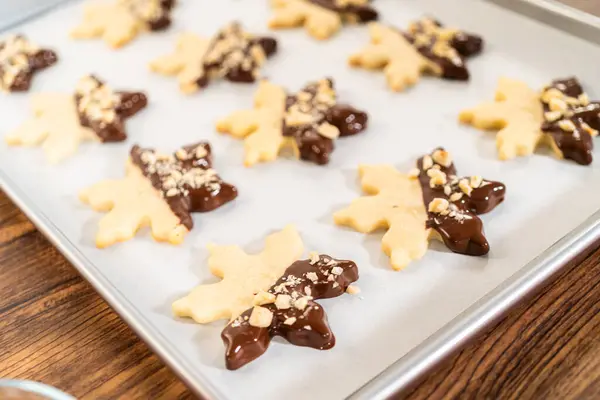 Creating Cutout Sugar Cookies Partially Dipped Chocolate Topped Hazelnut Pieces — Stock Photo, Image