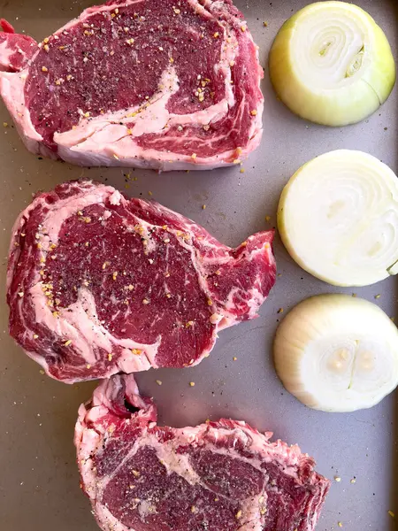 Three Raw Ribeye Steaks Marbling Liberally Seasoned Coarse Spices Lie — Stock Photo, Image