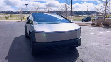 Denver, Colorado, ABD-28 Nisan 2024 - Bu görüntü, yenilikçi yapısını ve yansıtıcı yüzeyini geniş bir alana park etmiş bir Tesla Siber Kamyonu 'nun cesur ve açısal ön tasarımını vurguluyor.