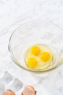 Measured ingredients in glass mixing bowls to bake American flag mini cupcakes.