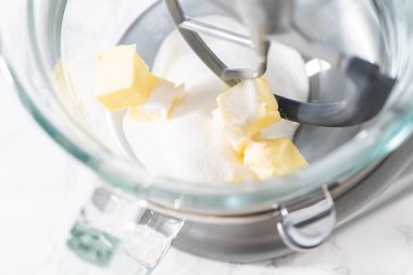 Mixing ingredients in kitchen electric mixer to bake American flag mini cupcakes.