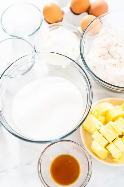 stock image Measured ingredients in glass mixing bowls to bake red velvet bundt cake with cream cheese glaze.