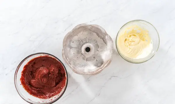 stock image Flat lay. Filling metal bundt cake pan with cake butter to bake red velvet bundt cake with cream cheese glaze