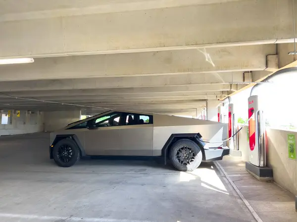 stock image Denver, Colorado, USA-May 31, 2024-A Tesla Cybertruck parked in an indoor charging station, showcasing its futuristic design and rugged build. The setting highlights the vehicles presence in a modern