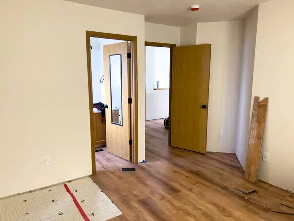 stock image Broomfield, Colorado, USA-July 14, 2024- The image showcases a newly installed wood floor in a home currently undergoing renovation. The scene includes visible tools and equipment used in the