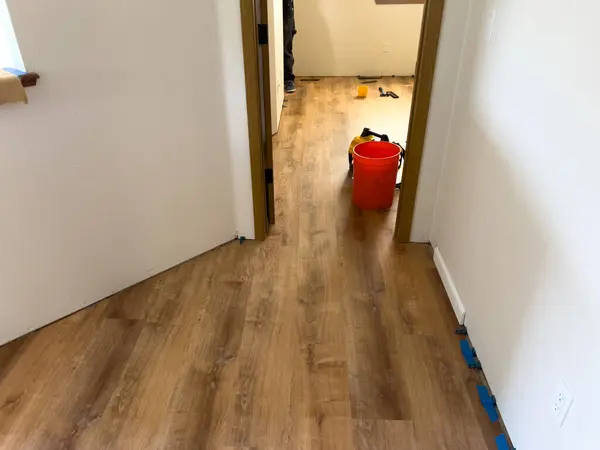 stock image Broomfield, Colorado, USA-July 7, 2024-Image showcasing newly installed vinyl plank flooring in a residential space. The smooth, wooden texture adds a fresh and modern touch to the interior, with