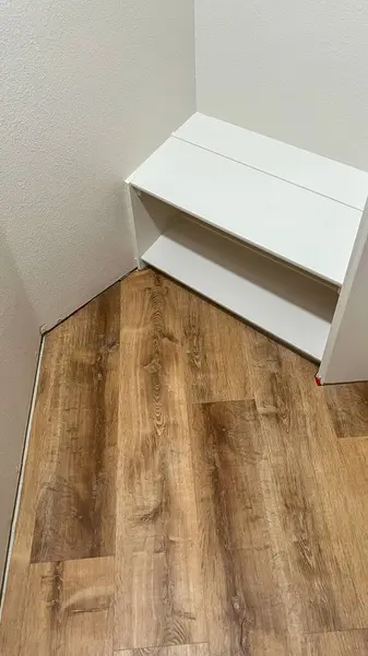 stock image Broomfield, Colorado, USA-July 6, 2024-A view of newly installed laminate flooring in a small closet. The wooden planks are neatly aligned, showcasing a smooth and polished finish. The closet features