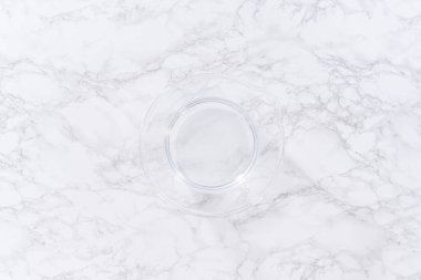 İçi su dolu geniş bir cam karıştırma kabı olgun çilekleri nazikçe temizlemek için hazır bekliyor. Kurumadan ya da depolamadan önce el değmemiş olduklarından emin olmak için..