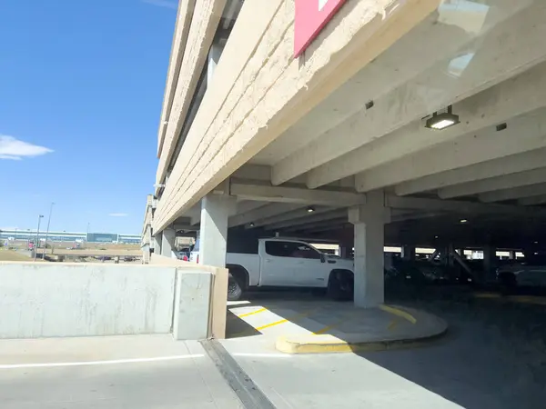 stock image Denver, Colorado, USA-August 15, 2024-Image of the entrance to a multi-level parking garage at Denver International Airport. The scene includes a clearance bar indicating an 8-foot height restriction