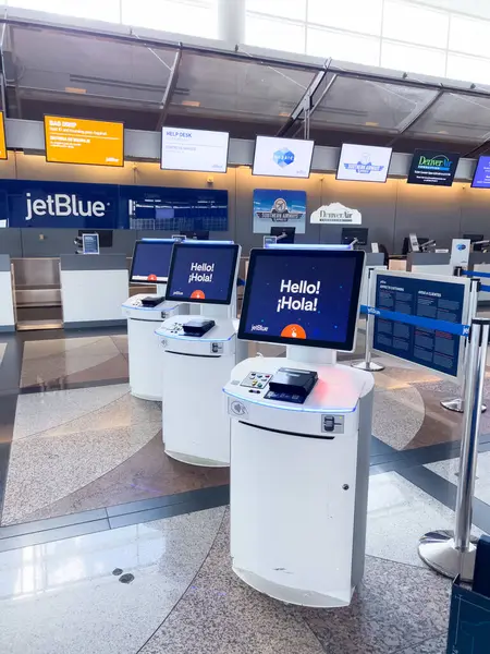 stock image Denver, Colorado, USA-August 15, 2024-A view of self check-in kiosks at Denver International Airport DIA, featuring JetBlue airline branding. The kiosks are set up in the terminal, with bright