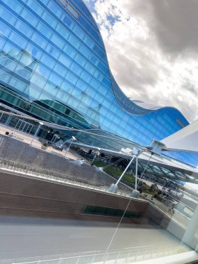 Denver, Colorado, ABD-15 Ağustos 2024 - Denver Uluslararası Havaalanı DIA 'daki otelin eğimli cam cephesinin çarpıcı görüntüsü. Modern mimaride yansıtıcı mavi cam bulunur.