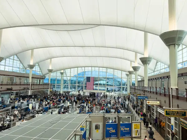 stock image Denver, Colorado, USA-August 15, 2024-A high-angle view of a crowded TSA security checkpoint at Denver International Airport DIA. The image captures the bustling scene of travelers going through the