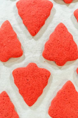 Close-up of baked Red Gingerbread Cookies in holiday shapes, displayed on a baking tray. clipart