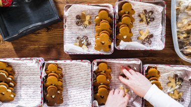 Flat lay. Lovingly homemade gingerbread and sugar cookies, half-dipped in rich chocolate, nestled in decorative Christmas tin boxes perfect for seasonal gifting. clipart