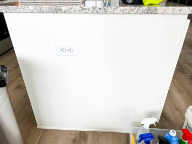 Castle Rock, Colorado, USA-March 16, 2023-Modern kitchen featuring white cabinets with silver handles, granite countertops, and a hexagon tile backsplash. Countertop appliances include an air fryer clipart