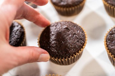 Taze pişmiş çikolatalı kekler, zengin ve kadife çikolatalı dondurmanın cömert bir kaplamasını beklerken enfes bir dönüşüm için hazırlanıyorlar..