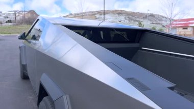 Denver, Colorado, ABD-5 Mayıs 2024 Tesla Siber Kamyonu 'nun yararını gösteren bu görüntü, geniş ve işlevsel tasarımını ön plana çıkaran ve banliyöde park etmiş araçları gösteriyor.
