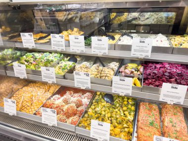 Castle Rock, Colorado, ABD-22 Şubat 2025 iyi stoklanmış Whole Foods şarküterisi çeşitli taze ve hazır gıdalar sergiliyor. Seçeneklerde kızarmış sebze ve makarna gibi yan yemekler yer alıyor.