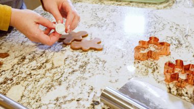 Çeşitli şenlikli kurabiye kesicilerle mermer tezgahtaki rulo hamurdan sevimli zencefilli kurabiyeler kesip modern mutfağa bayram neşesi getiriyorduk..