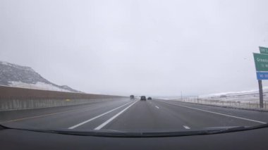 Denver, Colorado, ABD-26 Ocak 2024 - Karlı bir günde Denver 'dan Colorado Springs' e olan yolculuk devam ederken karla kaplı çam ağaçları I-25 'le huzurlu bir sürüş davet ediyor..