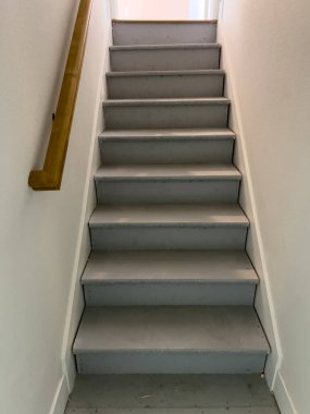 Üst kattaki koridora çıkan temiz merdiven boşluğu endüstriyel ve ev elementlerini birleştiriyor. Proje gösterileri öncesi ve sonrası için ideal.