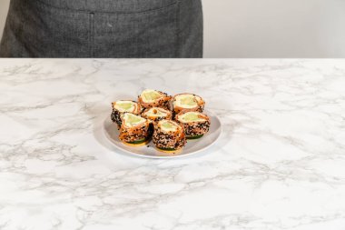 Tütsülenmiş somon peynirli peynirli ruloların daha yakın bir görüntüsü. Karmaşık tabakalarını ve taze malzemelerini vurguluyor..