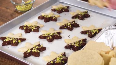 Yıldız şeklinde kurabiyeler hazırlıyorum, çikolataya yarı daldırılmış, bayram için naneli çikolata parçacıkları ile aksanlı..