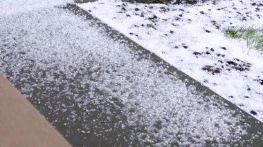 Dış yüzeyi yoğun bir şekilde kaplayan dolu taşlarını gösteren detaylı bir görüntü. Dolu taşları, dolu fırtınasının şiddetini gösteren kalın bir katman oluşturuyor..