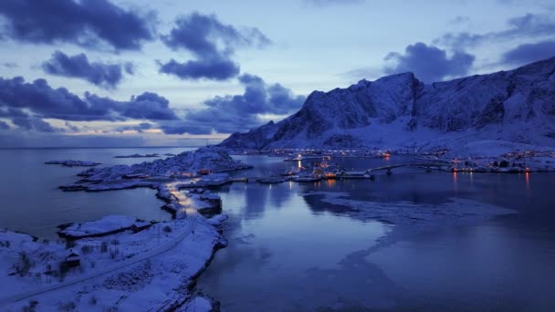 雪の山 夕日には冬のリボルバーの空中ビュー ノルウェーのロフテン諸島 フィヨルドのトップドローンビュー 夕暮れにピンクの雲が付いている青空の反射 レイク レイク — ストック動画