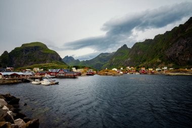 Nefes kesici bir sahil manzarası, renkli bir köyü yakalıyor. Güzel bir şekilde, yüksek dağların arasında yer alıyor.