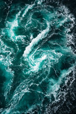 Bu hava manzarası dinamik okyanus sularını zengin deniz mavisi tonlarıyla gösteriyor. Büyüleyici bir merak hissi yaratıyor.