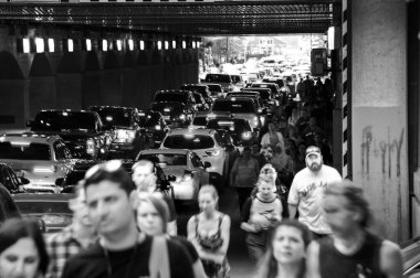Toronto, Canada - 07 01 2022: Hurrying people and cars lined up in the crammed tunnel under Union Station building in York street in downtown of the largest Candian city - Toronto. Black and white