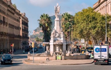 Barcelona, Catalonia, Spain - 08 04 2023: Font del Geni Catala statue on Pla del Palau square of Av. del Marques de lArgentera street in Barcelona with Montjuic hill in the background. clipart