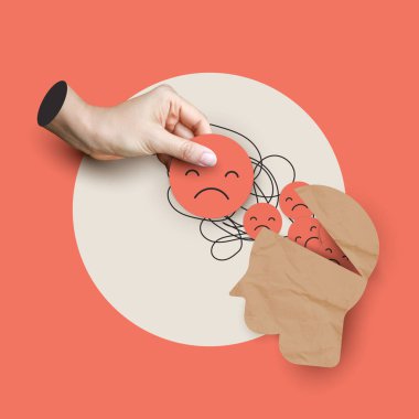 Zihinsel sağlık konsepti, kağıttan yapılmış insan kafasından üzgün bir yüzü çıkaran bir eli gösteriyor. Duygusal mücadelelerin, depresyonun, stresin, kaygının ve zihinsel sağlık desteğinin sembolik gösterimi.